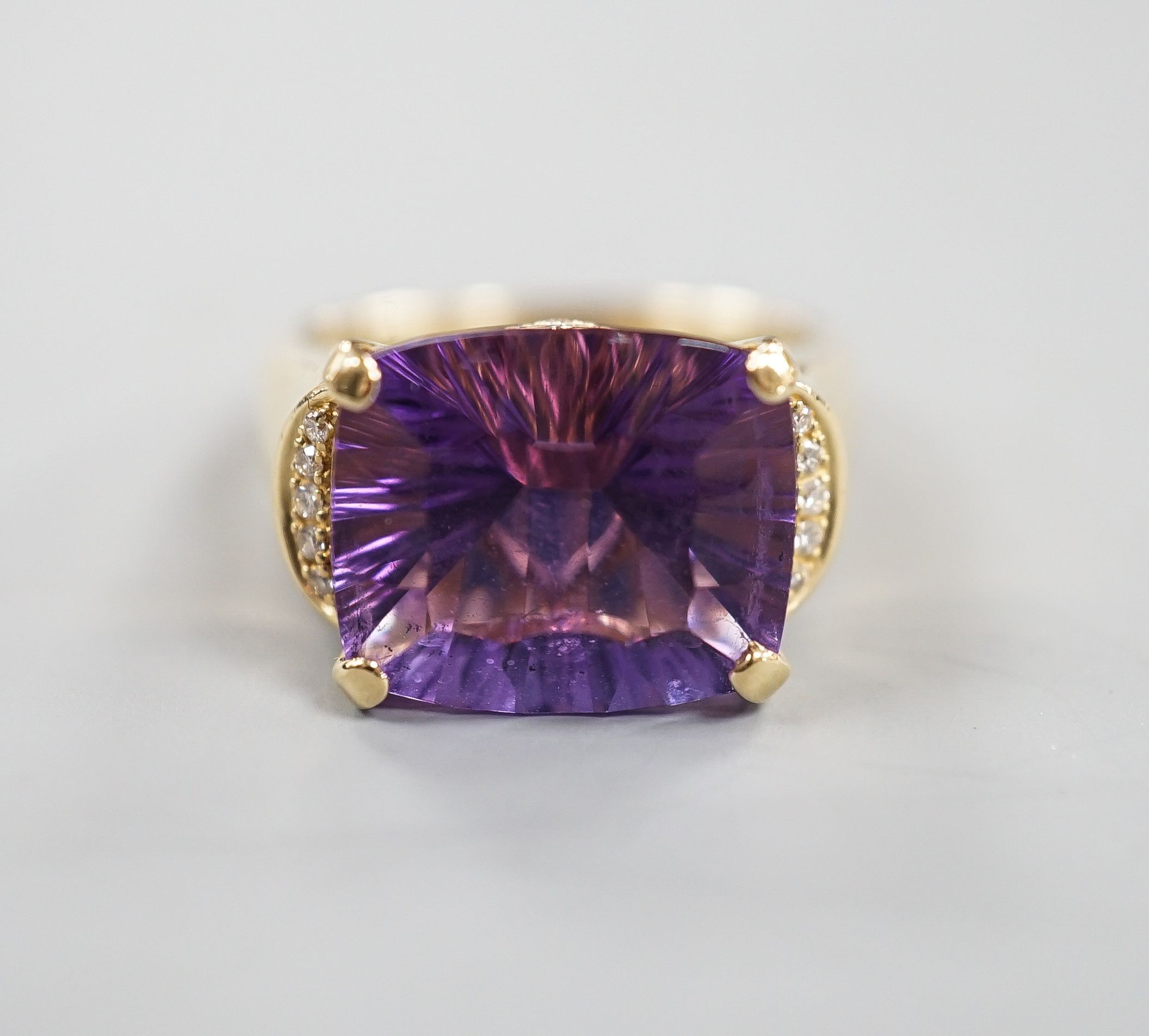 A modern 14k yellow metal, fancy cut amethyst and diamond chip set dress ring, size P/Q, gross weight 8 grams.